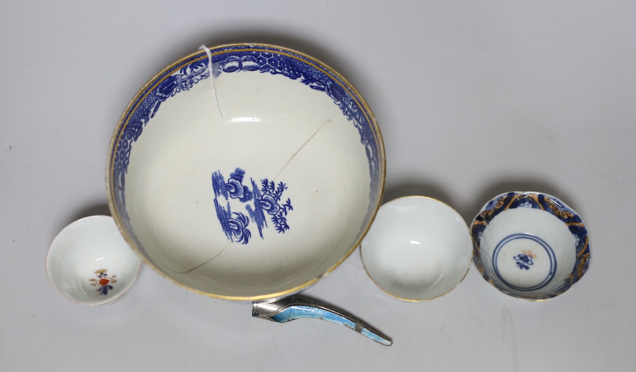 An English porcelain blue and white slop bowl, 15cm diameter, together with three miniature Chinese tea bowls and one nail guard